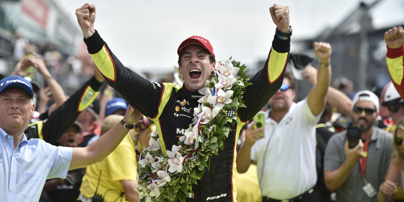 Simon Pagenaud celebrates victory with hands raised in victory lane at the 2019 Indianapolis 500