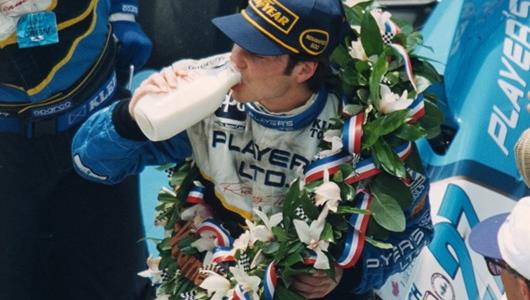Jacques Villeneuve drinks milk in Victory Circle after winning the 1995 Indianapolis 500 at the Indianapolis Motor Speedway.