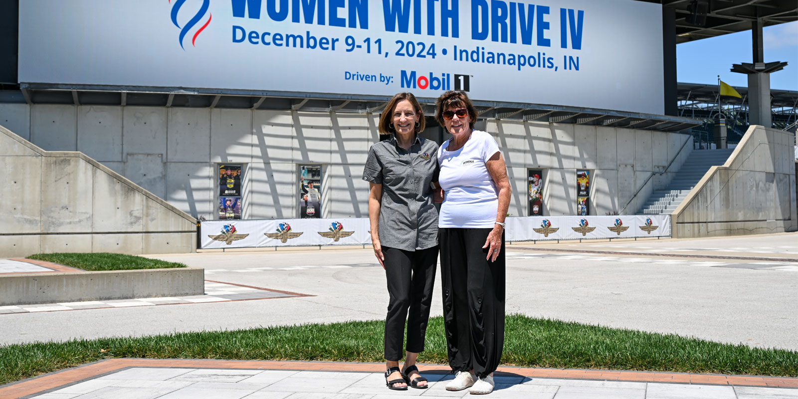 Allison Melangton and Lyn St. James pose in the plaza at Indianapolis Motor Speedway