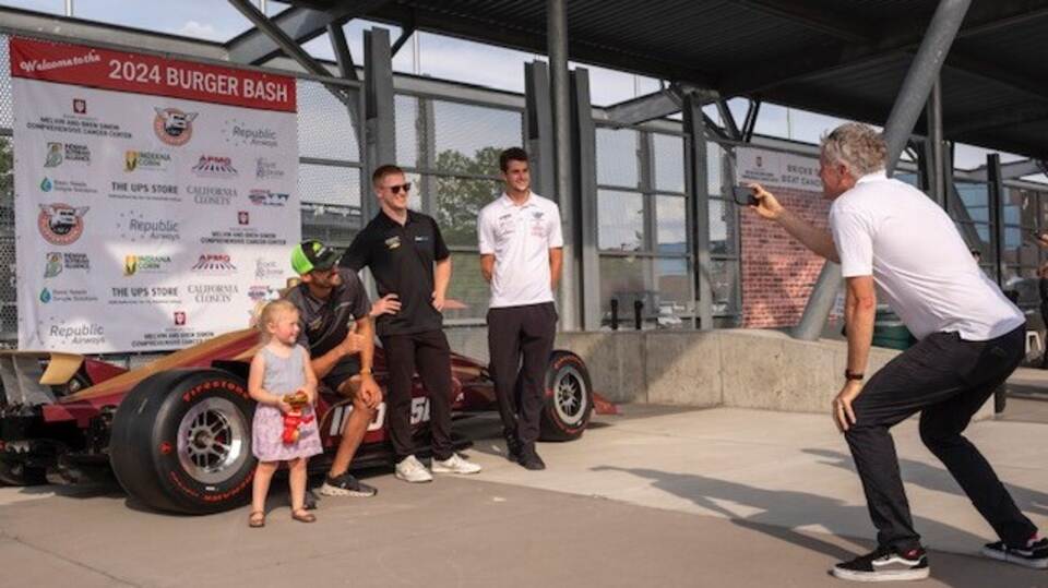 Drivers Pose with a fan at the Burger Bash