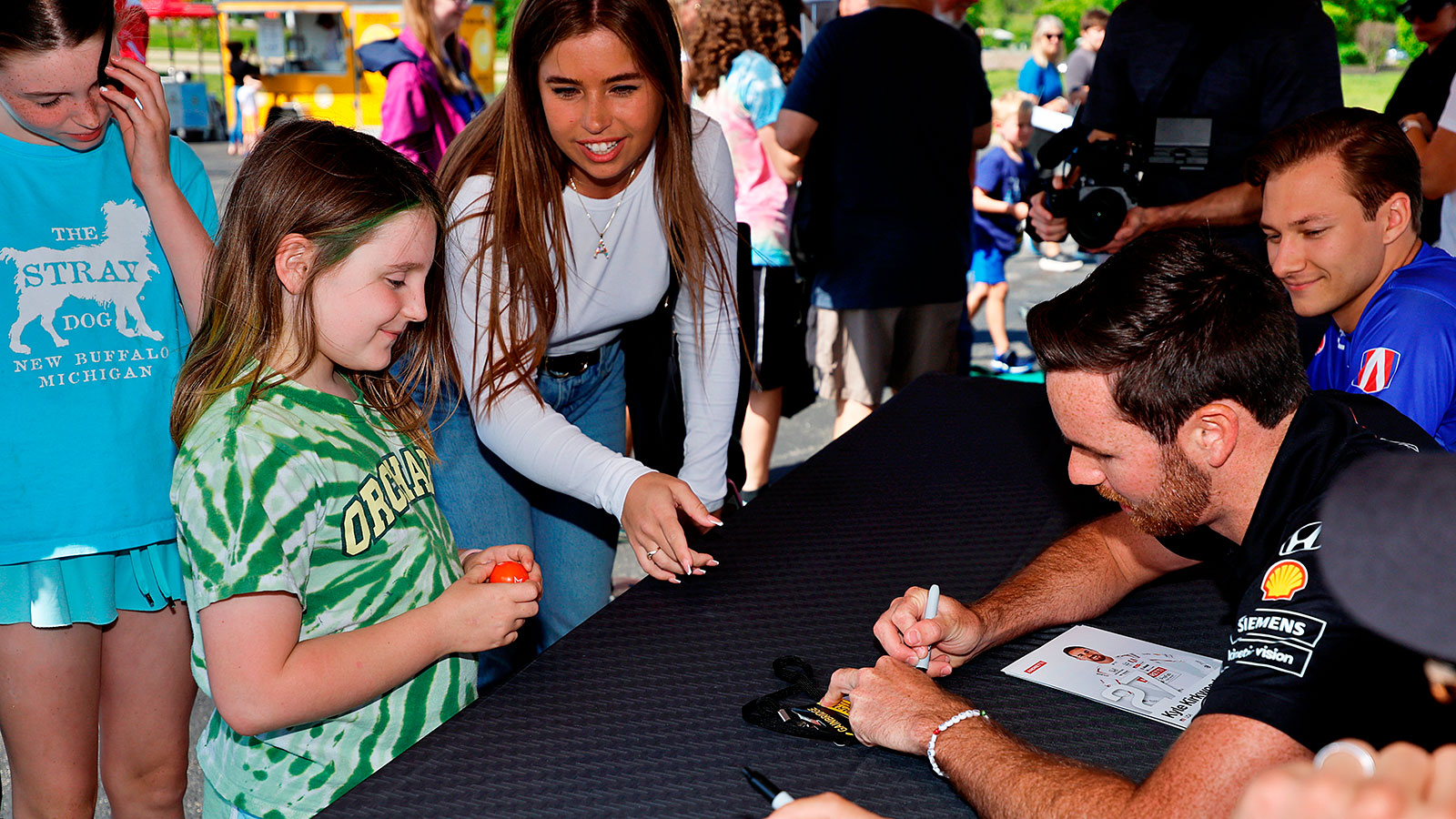 Kyle Kirkwood signs an autograph