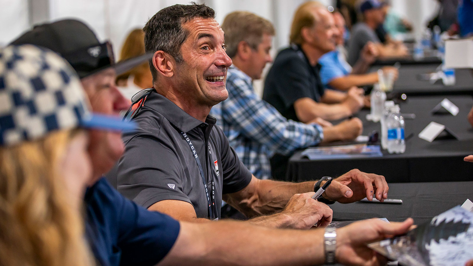 A veteran driver signs an autograph
