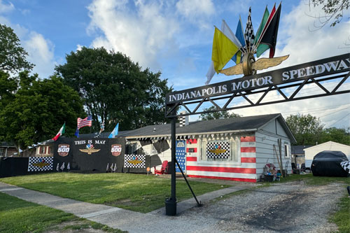 A yard heavily decorated with an Indianapolis Motor Speedway theme including a main gate