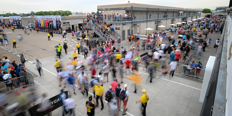 Fans file through gasoline alley