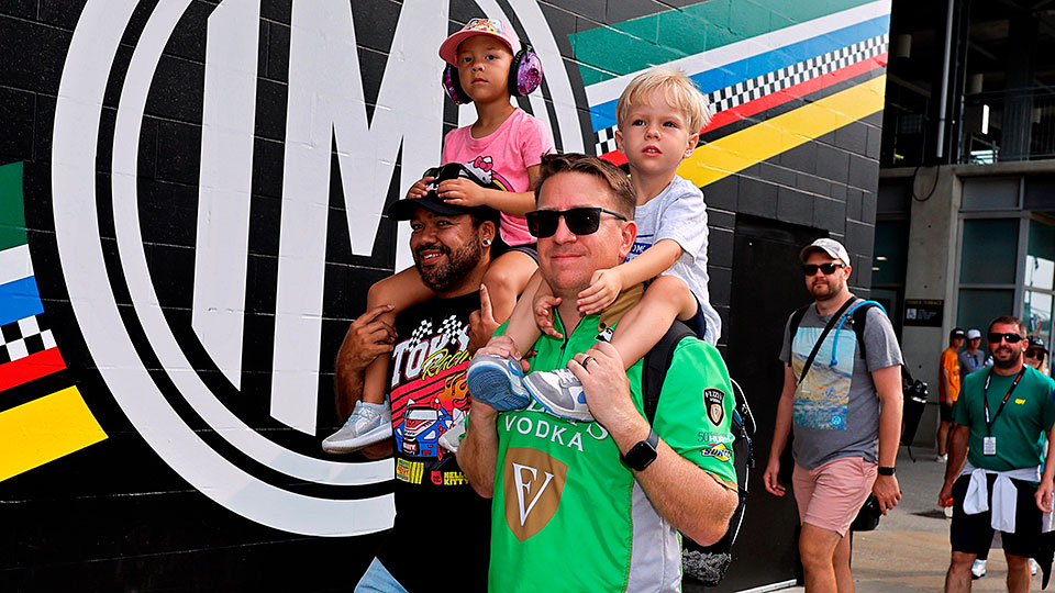 Fathers carry children on their shoulders