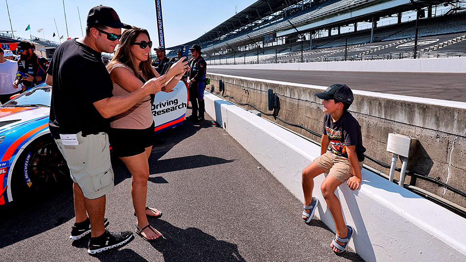 Parents take a photo of their child