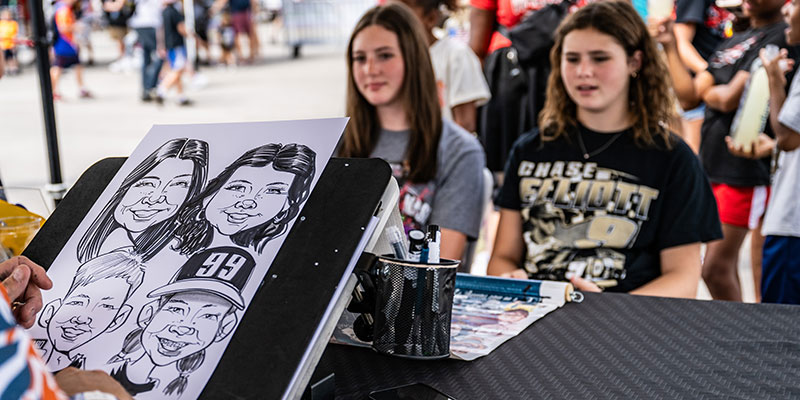 Girls Pose for a Caricature.