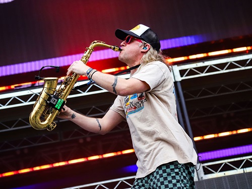A musical act plays the saxophone at the Snake Pit