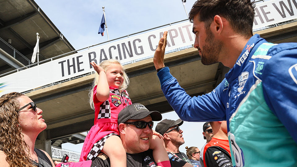 Rinus VeeKay high-fives a child