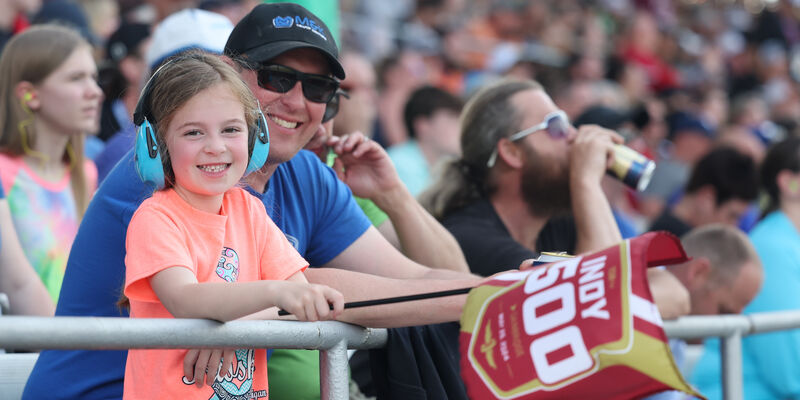 A father and daughter enjoy the Indy 500.