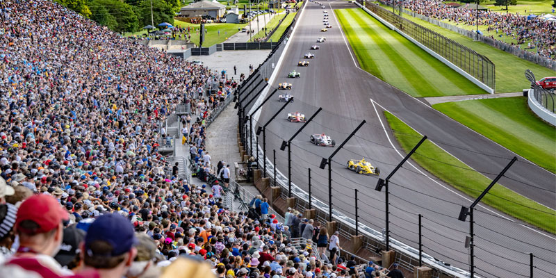 Fans filling the stands as the Indianapolis 500 field enters turn three of the oval