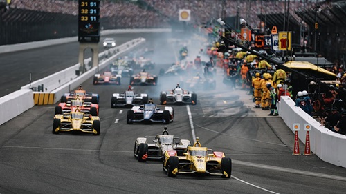 The cars race out of the pits