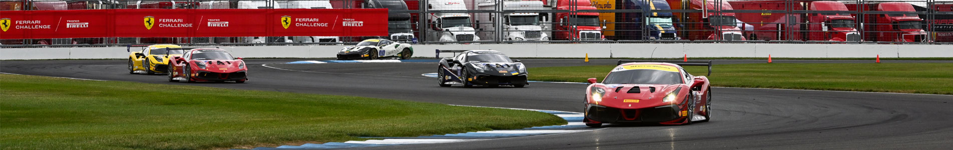 Multiple Ferrari vehicles navigate the infield section of Indianapolis Motor Speedway in 2022