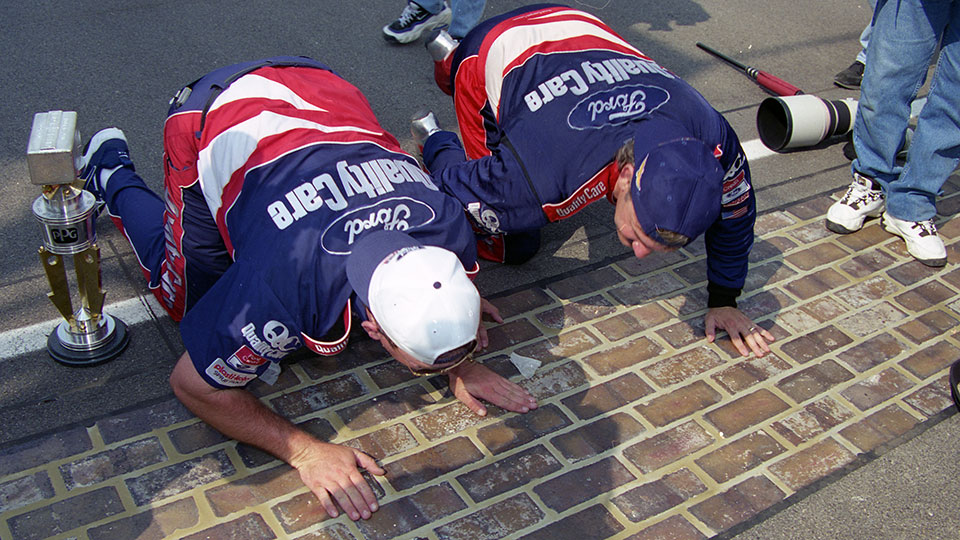 Dale Jarrett kisses the bricks