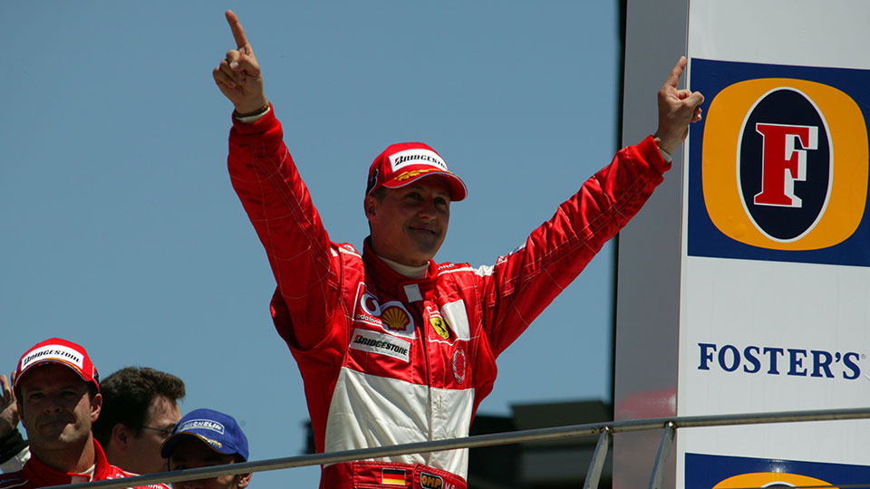 Michael Schumacher celebrates winning