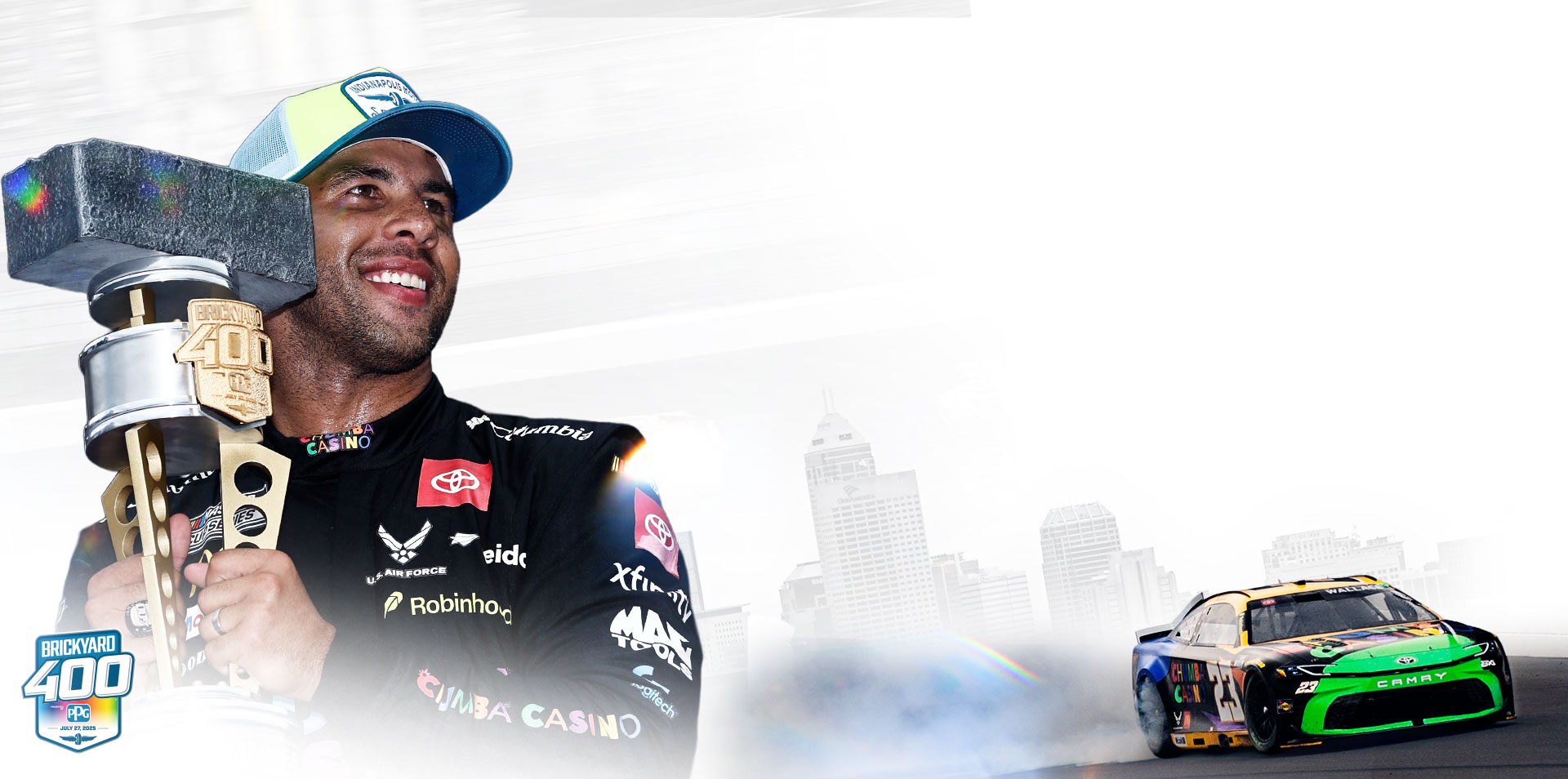 A composite image showing Bubba Wallace celebrating victory over a stylized image of his can in front of the Indianapolis skyline