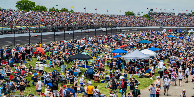 Thousands of fans in the stands and infield watching the 2023 Indianapolis 500