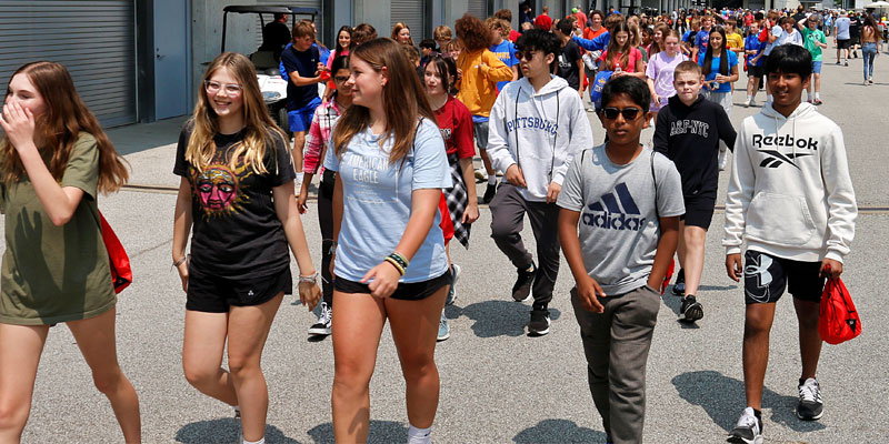 A school group walks through the IMS infield