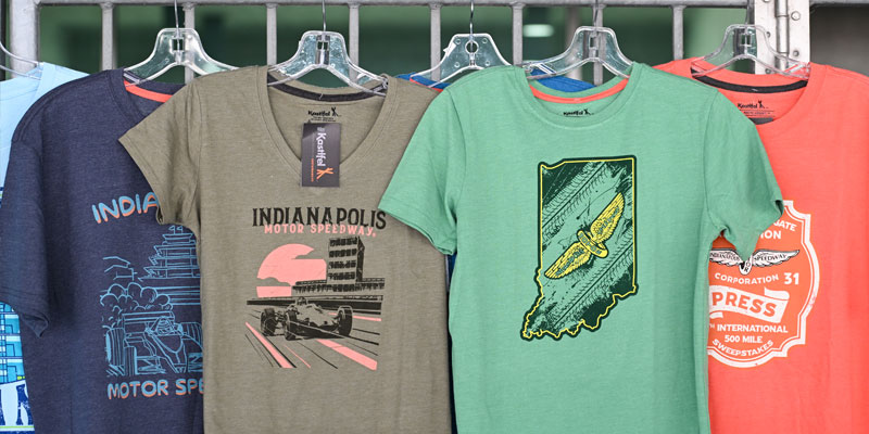 Multiple Indianapolis Motor Speedway shirts on hangers