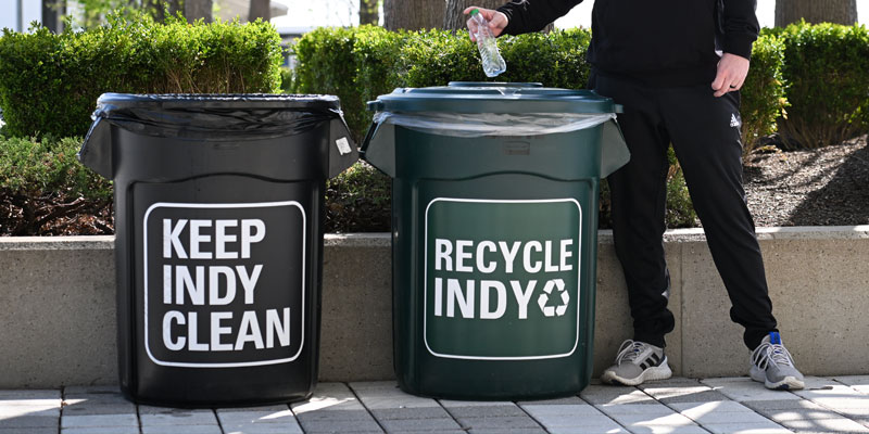 A plastic bottle is placed into a recycle bin at Indianapolis Motor Speedway